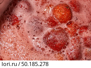 Homemade preparation of strawberry jam. Foam and juice when cooking strawberries. The process of making strawberry jam. Close-up of boiling strawberries. Стоковое фото, фотограф Андрей Жигальцов / Фотобанк Лори