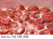 Homemade preparation of strawberry jam. Foam and juice when cooking strawberries. The process of making strawberry jam. Close-up of boiling strawberries. Стоковое фото, фотограф Андрей Жигальцов / Фотобанк Лори