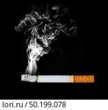 smoking cigarette on black background. Стоковое фото, агентство Ingram Publishing / Фотобанк Лори