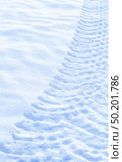 Tractor clear trail tracks in snow blue tone sunny day. Стоковое фото, фотограф Camptoloma / Фотобанк Лори