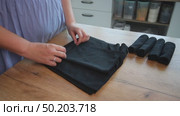 Woman reviewing microfiber car care cloths& Rolls napkins into a roll. Стоковое видео, видеограф Vadzim Yakubovich / Фотобанк Лори