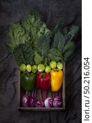 Healthy food clean eating selection in wooden box: fruit, vegetable, seeds, superfood, cereals, leaf vegetable on gray background. Стоковое фото, агентство Ingram Publishing / Фотобанк Лори