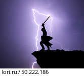 Warrior silhoutte and lightning. Strenght and power conceptual scene. Стоковое фото, агентство Ingram Publishing / Фотобанк Лори