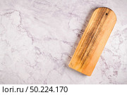 Top view of wooden cutting board on a gray marble background with space for text. Стоковое фото, агентство Ingram Publishing / Фотобанк Лори