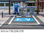 EV Station Charger for electrical vehicle car using as green environmental concept. Стоковое фото, агентство Ingram Publishing / Фотобанк Лори