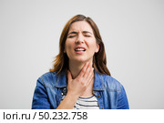 Frustrated woman in pain with a sore throat. Стоковое фото, агентство Ingram Publishing / Фотобанк Лори