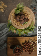 Delicious naked coffee and hazelnuts cake on table rustic wood kitchen countertop. Стоковое фото, агентство Ingram Publishing / Фотобанк Лори