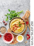Chickpea hummus with tahini in a bowl. Healthy vegetarian appetizer. Middle Eastern cuisine. Стоковое фото, агентство Ingram Publishing / Фотобанк Лори
