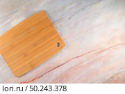 Top view of wooden cutting board on a gray marble background with space for text. Стоковое фото, агентство Ingram Publishing / Фотобанк Лори