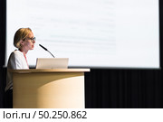 Female speaker giving a talk on corporate business conference. Business and Entrepreneurship event. Стоковое фото, фотограф Matej Kastelic / Фотобанк Лори