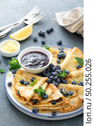 Crepes, thin pancakes with blueberry jam and fresh berries with lemon zest. Стоковое фото, агентство Ingram Publishing / Фотобанк Лори
