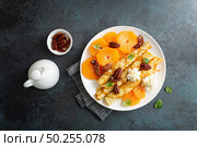 Crepes, thin pancakes with fresh tangerine slices, pecan nuts, syrup and whipped cream. Стоковое фото, агентство Ingram Publishing / Фотобанк Лори