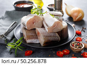 Raw fresh sliced hake fish with ingredients for cooking. Стоковое фото, агентство Ingram Publishing / Фотобанк Лори