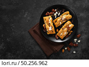 Homemade chocolate puff pastry braided strudel, pie with pecan nuts and almond, top view. Стоковое фото, агентство Ingram Publishing / Фотобанк Лори