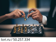 Close up shot golden chess to defeat killing silver king chess on white and black chess board for business challenge competition winner and loser concept, selective. Стоковое фото, агентство Ingram Publishing / Фотобанк Лори