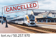 Trains cancelled due to pandemic of coronavirus. Passenger railway travel and transportation cancellation due to epidemic of Covid-19.  Background with railway station, high speed train and text . Стоковое фото, агентство Ingram Publishing / Фотобанк Лори