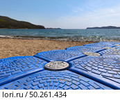 Old plastic blue pontoon on a sandy shore in a bay. Стоковое фото, фотограф Кирилл Зотов / Фотобанк Лори