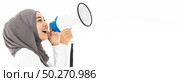 Young adult muslim arab woman wearing hijab communicates shouting loud holding a megaphone using for idea for marketing or sales. Studio shot isolated on white background. Panoramic web banner crop. Стоковое фото, агентство Ingram Publishing / Фотобанк Лори