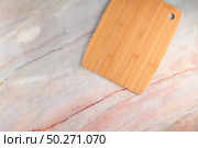 Top view of wooden cutting board on a gray marble background with space for text. Стоковое фото, агентство Ingram Publishing / Фотобанк Лори