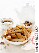 Biscotti cookies with dried cranberry, walnuts and with a cup of coffee . Стоковое фото, агентство Ingram Publishing / Фотобанк Лори