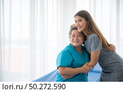 The daughter visits the grandmother who is sick in the hospital. Стоковое фото, агентство Ingram Publishing / Фотобанк Лори