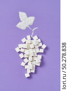 Decorative composition from grape fruit handmade from different types of sweet sugar refined cubes and leaf from granulated sugar on a lavender background, copy space. Flat lay.. Refined sugar cubes as a grape fruit with leaf from granulated sugar. Стоковое фото, агентство Ingram Publishing / Фотобанк Лори