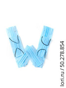 Capital letter W handmade from medical antibacterial protective blue face masks on a white background, copy space. Creative alphabet for making up new words.. Letter W made from protective medical masks on a white background. Стоковое фото, агентство Ingram Publishing / Фотобанк Лори