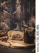 Vegan chocolate spread made of organic almond butter and organic cacao and honey, on dark rustic kitchen counter top. Стоковое фото, агентство Ingram Publishing / Фотобанк Лори