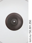 White vinyl record rotate background. Old fashioned turntable player. Sound technology for DJ to mix and play music.. Retro white vinil record as a creative background. Стоковое фото, агентство Ingram Publishing / Фотобанк Лори