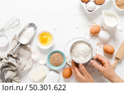 Baking homemade bread on white kitchen worktop with ingredients for cooking, culinary background, copy space, overhead view. Стоковое фото, агентство Ingram Publishing / Фотобанк Лори