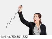 Beautiful woman drawing a chart with a recent ascent of the company. Стоковое фото, агентство Ingram Publishing / Фотобанк Лори
