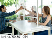 Asian customers cheers and celebrating social distancing in restaurant. New normal lifestyle in food and drink concept. Стоковое фото, агентство Ingram Publishing / Фотобанк Лори
