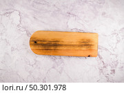 Top view of wooden cutting board on a gray marble background with space for text. Стоковое фото, агентство Ingram Publishing / Фотобанк Лори