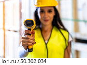 Close up of caucasian white woman warehouse worker hold hand scanner to check inventory stock in distribution warehouse. Traceability FIFO LIFO inventory just in time and warehouse concept photo. Стоковое фото, агентство Ingram Publishing / Фотобанк Лори