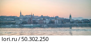 Sunrise panoramic view of historical bank of Danube river with old-fashioned buildings and houses in Budapest, Hungary.. Panoramic view of historical bank of Danube river in Budapest, Hungary. Стоковое фото, агентство Ingram Publishing / Фотобанк Лори