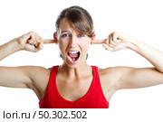Portrait of disturbed young woman screaming while putting her finger on the hears. Стоковое фото, агентство Ingram Publishing / Фотобанк Лори