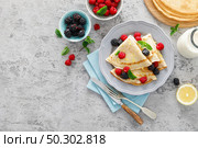Thin crepes with fresh berries and lemon zest. Pancakes with raspberry and blackberry. Стоковое фото, агентство Ingram Publishing / Фотобанк Лори