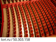 View of the empty parterre in the theatre concert hall of Vienna State Opera auditorium with red seats in the rows without people in Vienna, Austria.. The empty parterre in the concert hall of Vienna State Opera auditorium. Стоковое фото, агентство Ingram Publishing / Фотобанк Лори