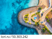 Aerial view of beautiful sandy beach, clear blue sea, promenade, swimming people in clear water, green trees at sunset in summer. Top view of seafront. Tropical landscape. View from drone of sea shore. Стоковое фото, агентство Ingram Publishing / Фотобанк Лори