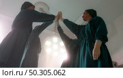 Panorama asian surgeons team joining hands together cheering and celebrate after operation success and rescue patient in operation room OR at hospital. Medical health care Surgery concept. Стоковое фото, агентство Ingram Publishing / Фотобанк Лори