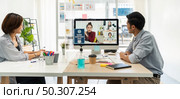 Panorama two asian businessperson work from home involved video conference meeting to corporate colleague for discuss and brainstorm distantly. This technology is popular after COVID-19 spreading. Стоковое фото, агентство Ingram Publishing / Фотобанк Лори