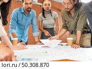 Close up group of asian caucasian business team meeting brainstorm on paper work analysis in meeting room after office reopen from city lockdown cause by coronavirus COVID-19 pandemic. Стоковое фото, агентство Ingram Publishing / Фотобанк Лори