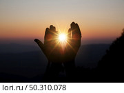 Faith of christian concept: Spiritual prayer hands over sun shine with blurred beautiful sunset background. Стоковое фото, агентство Ingram Publishing / Фотобанк Лори