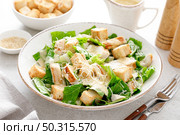 Caesar salad with parmesan cheese, grilled chicken meat and croutons. Стоковое фото, агентство Ingram Publishing / Фотобанк Лори