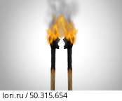 Mutual destruction and destroying each other due to a disagreement or toxic relationship fight in mutually destructive results as two matches shaped as angry people getting both burned and destroyed  with 3D render elements. Стоковое фото, агентство Ingram Publishing / Фотобанк Лори