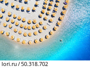 Aerial view of sea, empty sandy beach with sunbeds and umbrellas at sunny day in summer. Blue lagoon in Oludeniz, Turkey. Tropical landscape with clear turquoise water, deck chairs. Travel and leisure. Стоковое фото, агентство Ingram Publishing / Фотобанк Лори