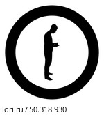 Man holding smartphone phone Playing tablet Male using communication tool Idea looking phone addiction Concept dependency from modern technologies silhouette in circle round black color vector illustration solid outline style simple image. Man holding smartphone phone Playing tablet Male using communication tool Idea looking phone addiction Concept dependency from modern technologies silhouette in circle round black color vector illustration solid outline style image. Стоковая иллюстрация, агентство Ingram Publishing / Фотобанк Лори
