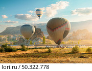 Hot air balloons flying over Cappadocia, Turkey. Hot air balloons in morning. Стоковое фото, агентство Ingram Publishing / Фотобанк Лори