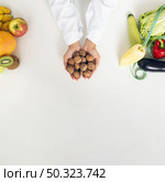 close up person with vegetables holding nuts. Стоковое фото, агентство Ingram Publishing / Фотобанк Лори