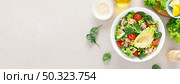 Avocado and tuna fresh vegetable salad with tomato, cucumber corn, onion, lettuce and spinach. Healthy and detox food concept. Ketogenic diet. Buddha bowl dish on light background, top view. Banner. Стоковое фото, агентство Ingram Publishing / Фотобанк Лори